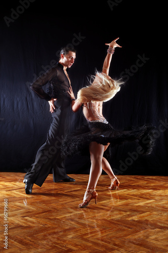 Fototapeta Naklejka Na Ścianę i Meble -  dancers in ballroom against black background