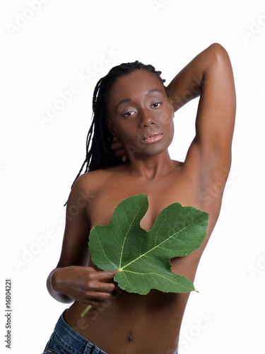 Young black woman covering breast with fig leaf