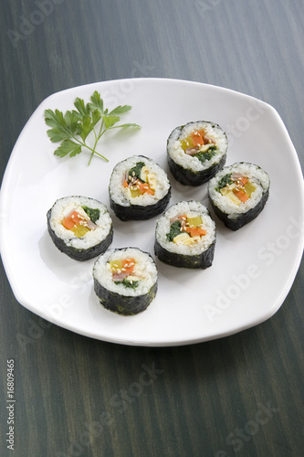 A type of sushi called kimbap and a parsley leaf.