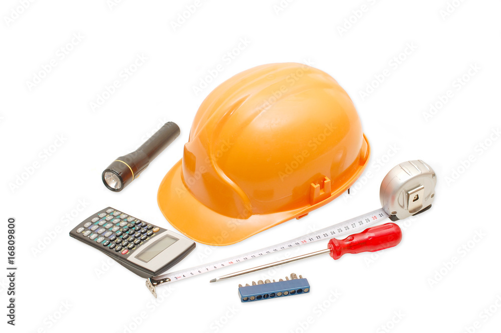 Orange helmet and the tool isolated on white background Orange helmet and the tool isolated on white background