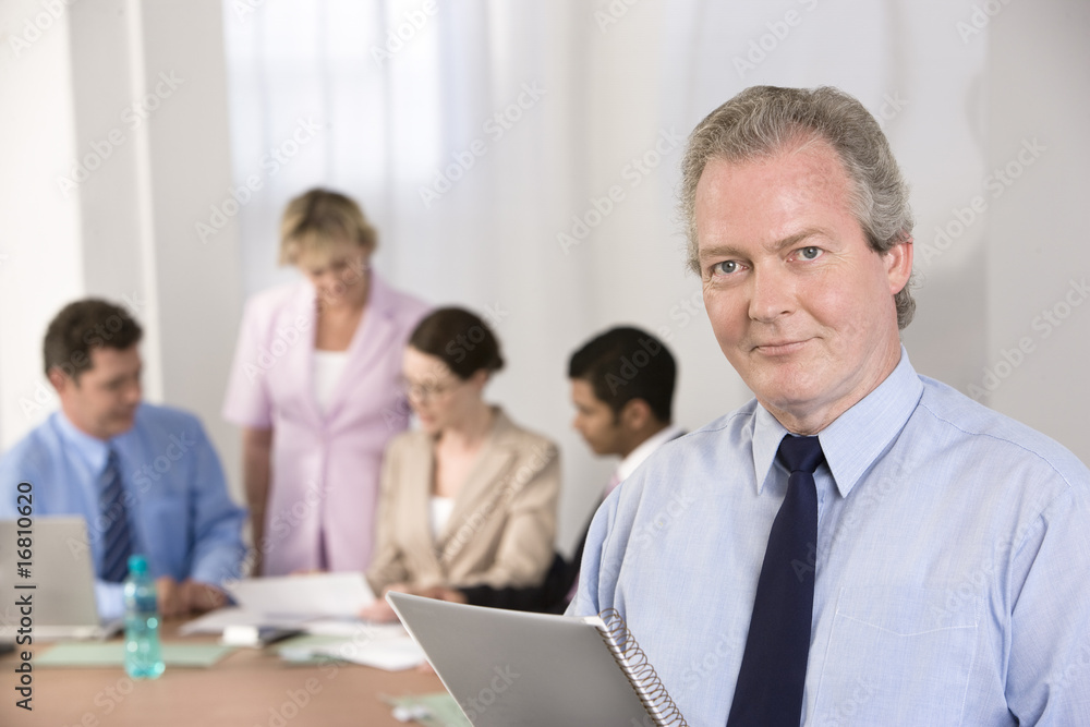 Portrait of businessman and his team. Portrait of businessman and his team.