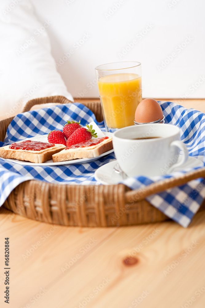 Homemade breakfast on wicker tray with checked teacloth Homemade breakfast on wicker tray with checked teacloth