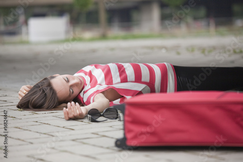 unconscious woman on asphalt road photo