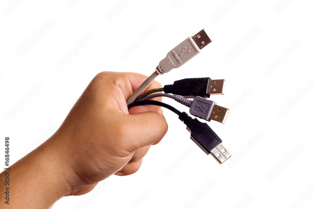 Hand holding bunch of computer cables Hand holding bunch of computer cables
