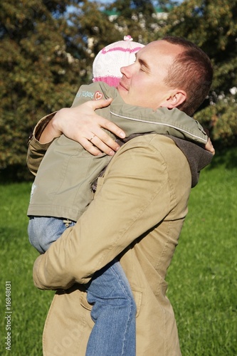 father hugs his little daughter