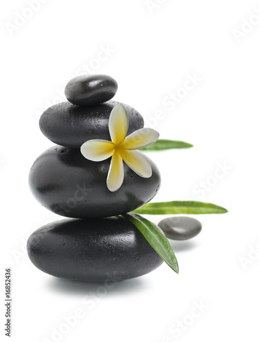 Spa still life  Stack of pebbles with yellow flower