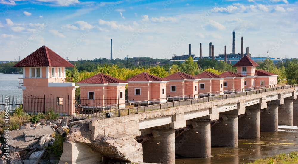 Old dam with industrial background