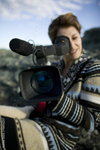 Girl with video camera © tstockphoto
