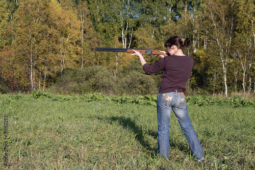 The girl aims from a gun