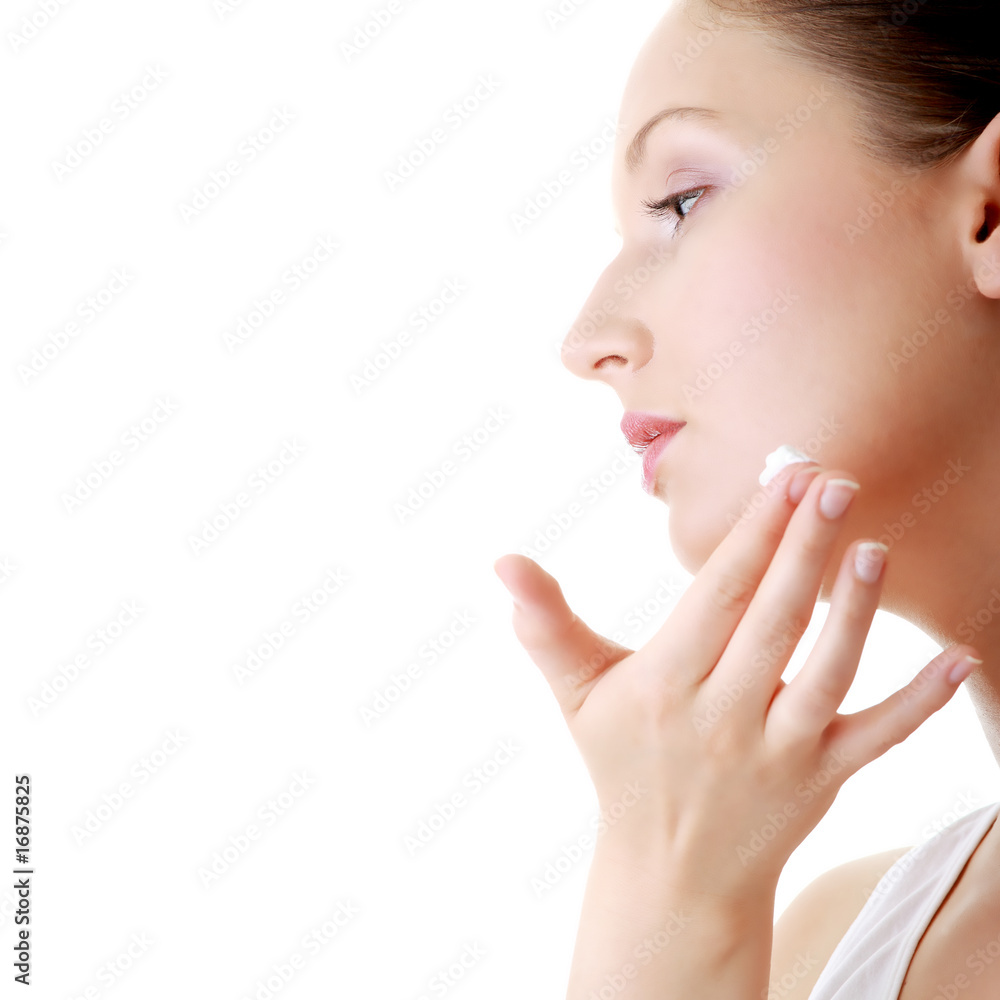 Woman applying moisturizer cream on face Woman applying moisturizer cream on face