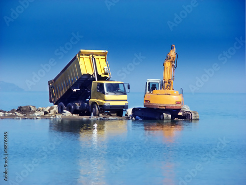 Excavator and dumper working in the sea