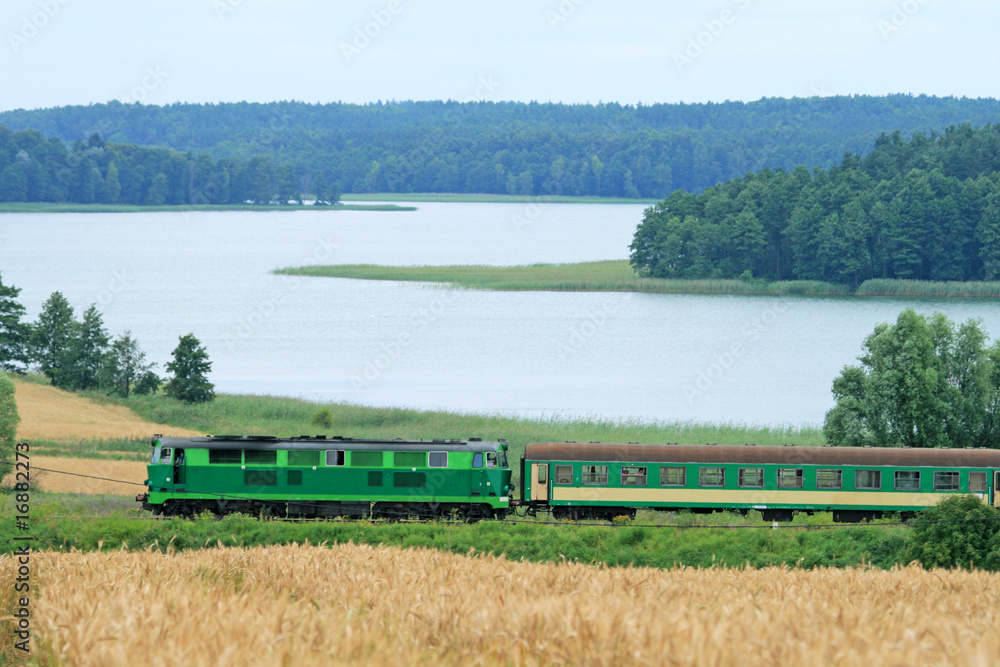 Fototapeta premium Passenger train passing through the lakeside