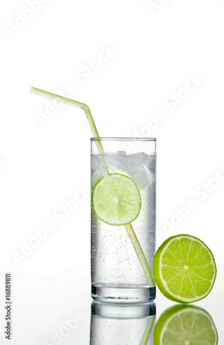 Glass of gin and tonic with ice and lime.