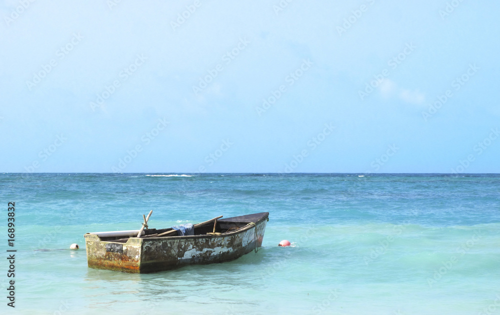 Old boat floating in the Caribbean Sea