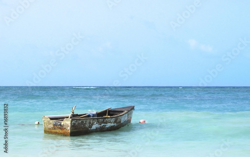 Old boat floating in the Caribbean Sea