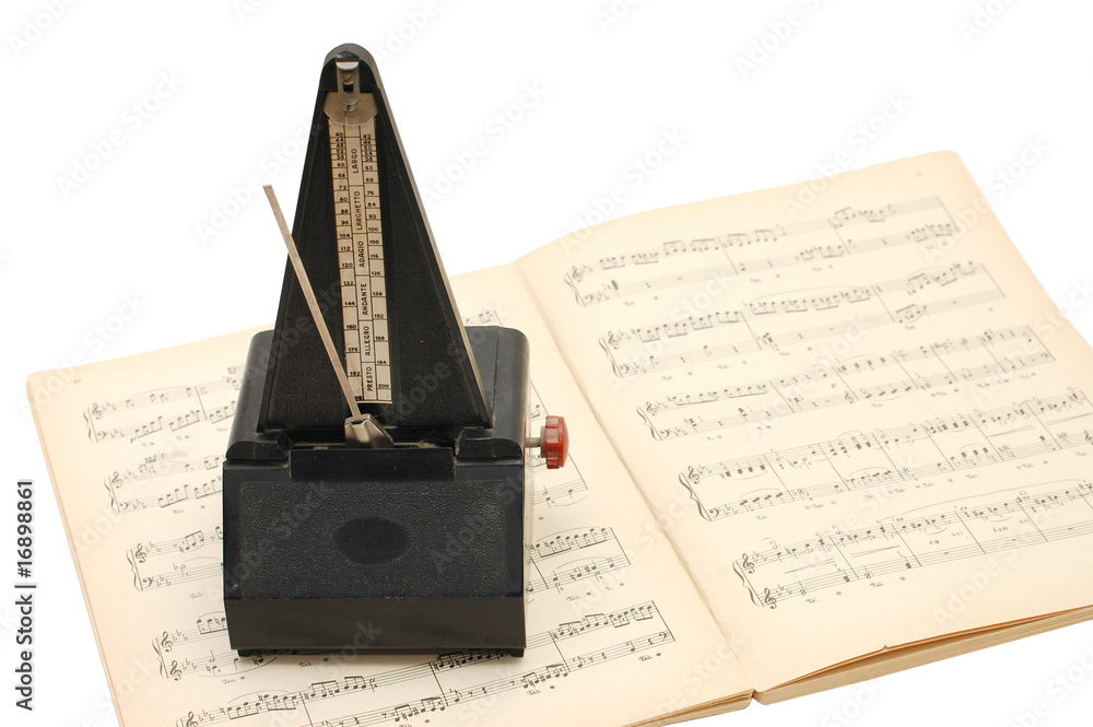 Fototapeta premium metronome on sheet music background