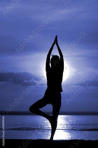 Silhouette of the women meditate on moon night