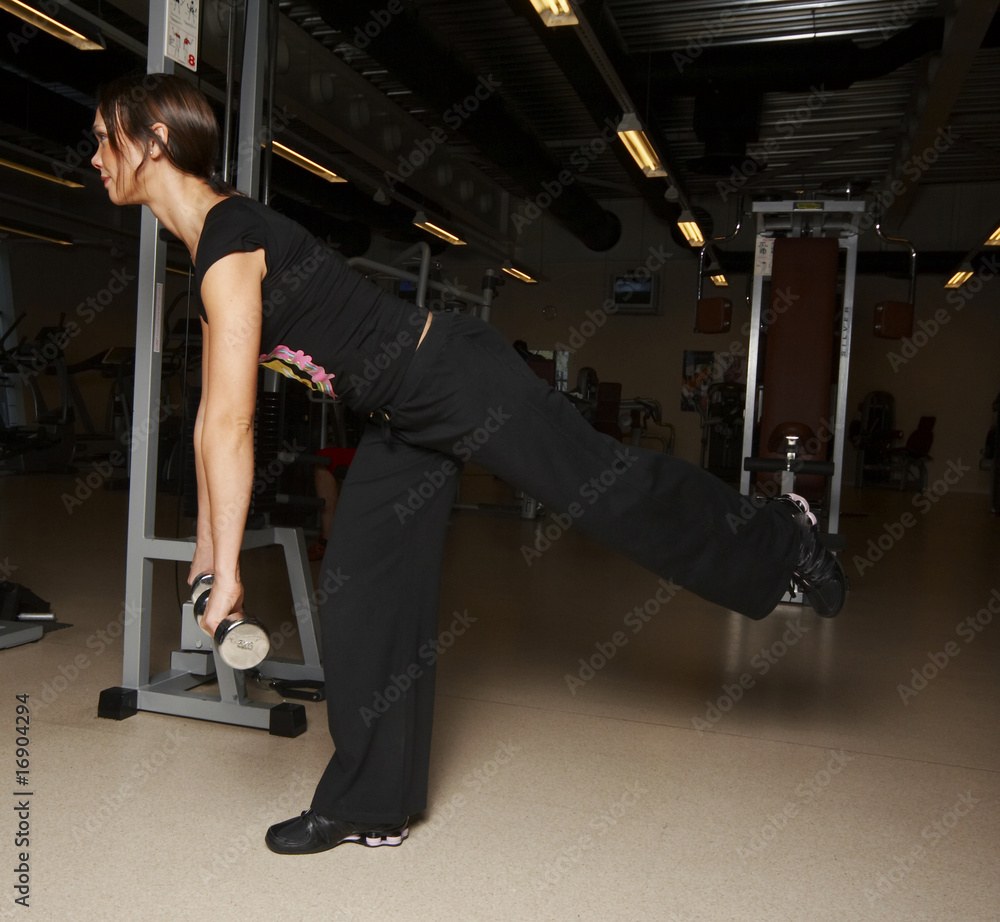 a female bodybuilder working out in gym a female bodybuilder working out in gym