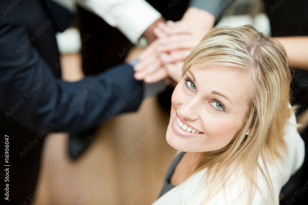 High view of hands together with a businesswoman smiling. High view of hands together with a businesswoman smiling.