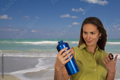 Woman holding blue bottle of water