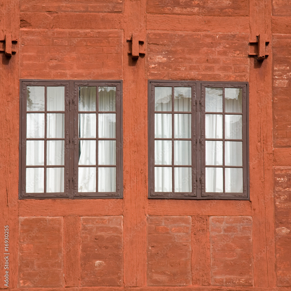 two old multipanel windows in a terracotta colored brick and woo two old multipanel windows in a terracotta colored brick and woo
