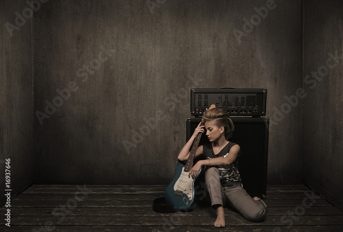 Girl with guitar in a vintage room photo