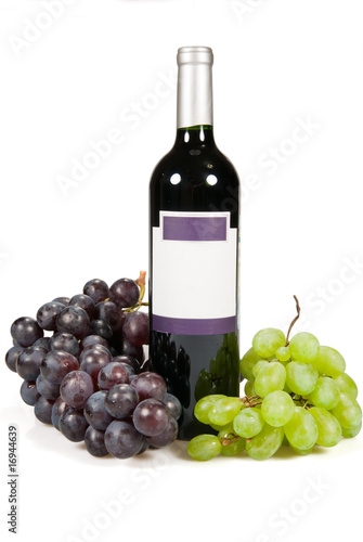 Bottle and grapes of red and green colour.
