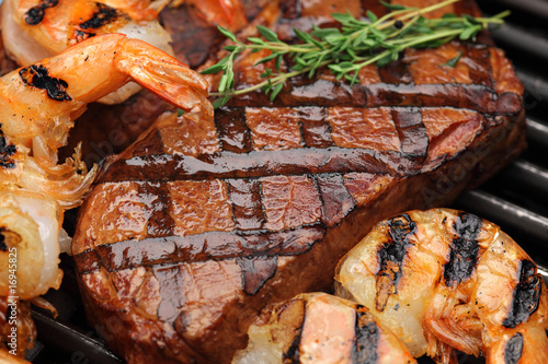 Juicy BBQ sirloin steak with grilled shrimps - Surf and Turf