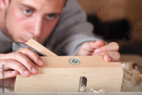 Carpenter working with plane