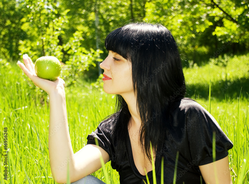 portrait of a young beautiful woman with apple in hand portrait of a young beautiful woman with apple in hand