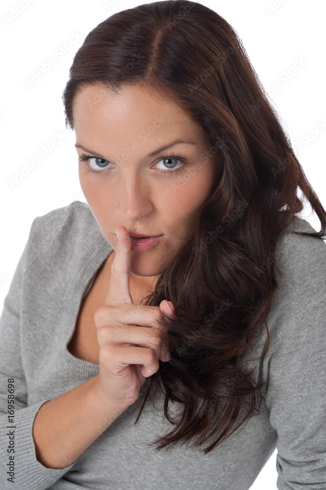 Beautiful woman expressing silence, finger on lips Beautiful woman expressing silence, finger on lips