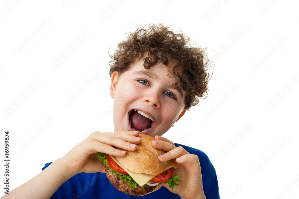 Boy eating big sandwich isolated on white background Boy eating big sandwich isolated on white background