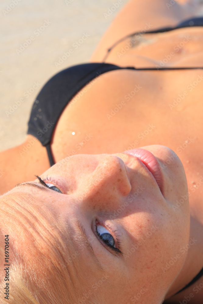 tanned blond woman in bikini in the sea tanned blond woman in bikini in the sea