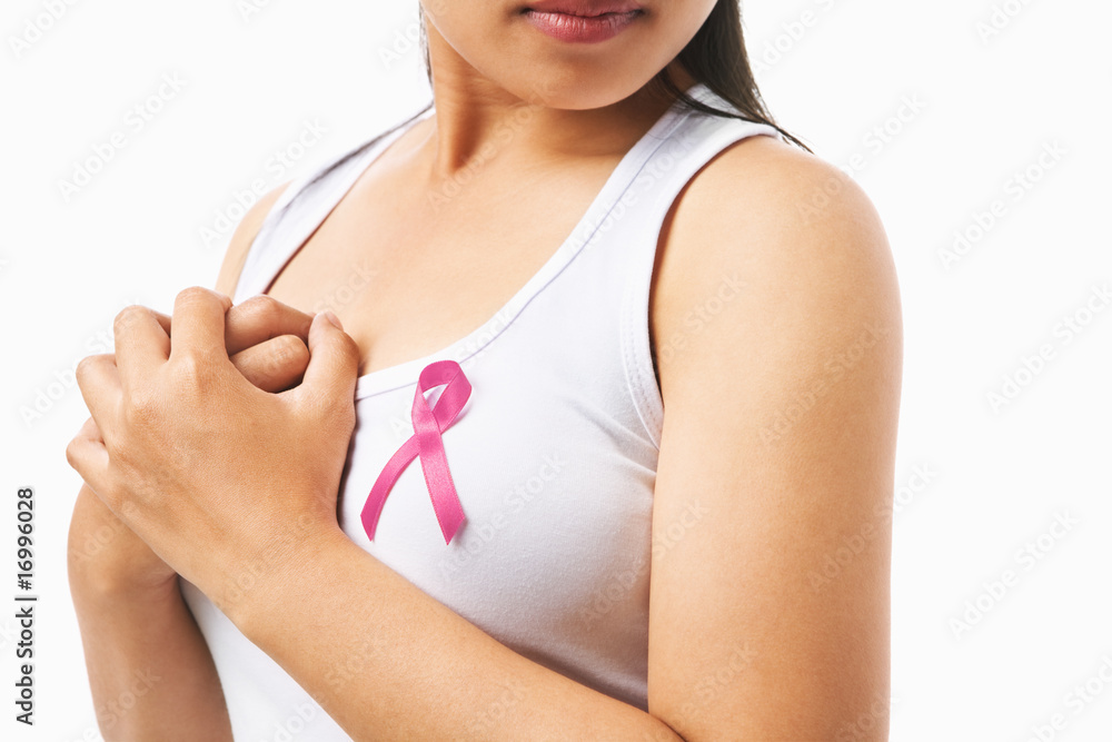 Pink badge on woman chest to support breat cancer cause Pink badge on woman chest to support breat cancer cause