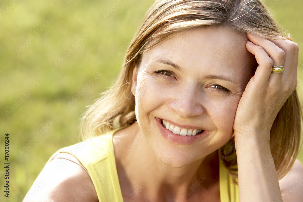 Portrait of young woman relaxing in countryside Portrait of young woman relaxing in countryside