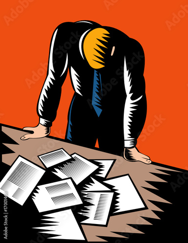 Male office worker hunched over paperwork