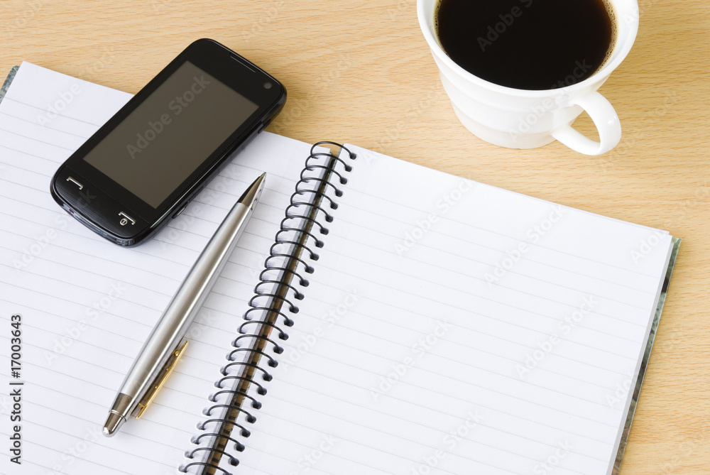Cell phone, notebook and cup of coffee Cell phone, notebook and cup of coffee