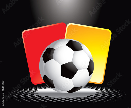 Soccer ball and penalty cards under spotlight