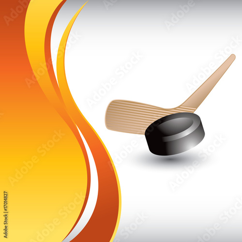 Ice hockey stick and puck on vertical orange wave backdrop