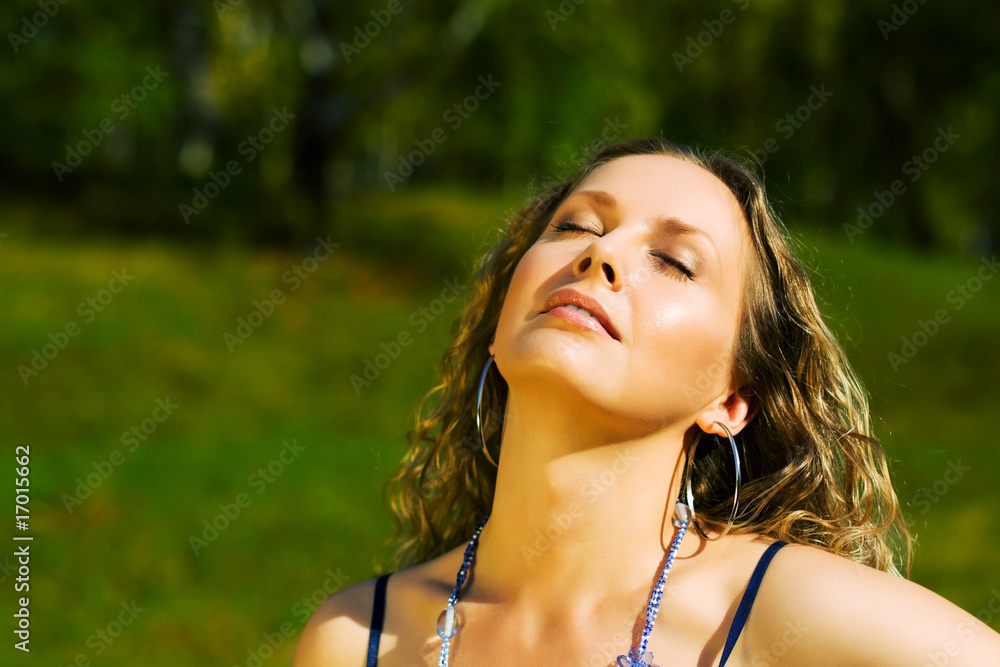 Young woman relaxing on nature. Young woman relaxing on nature.