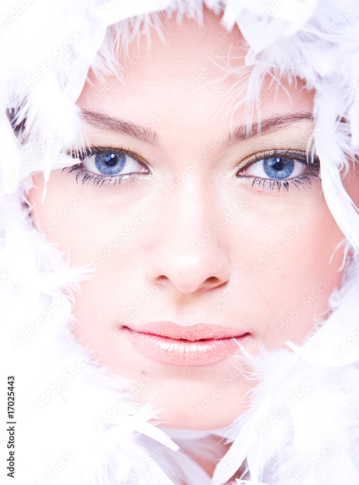 young woman with blue eyes and white boa over her face
