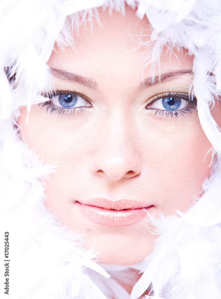 young woman with blue eyes and white boa over her face young woman with blue eyes and white boa over her face