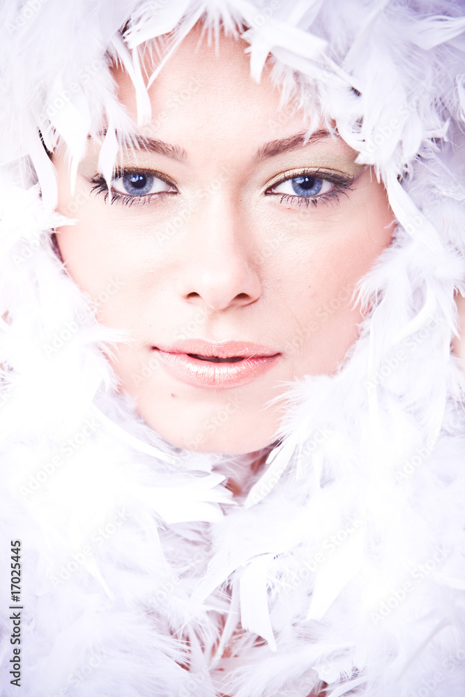 closeup portrait of young woman with white boa over her face