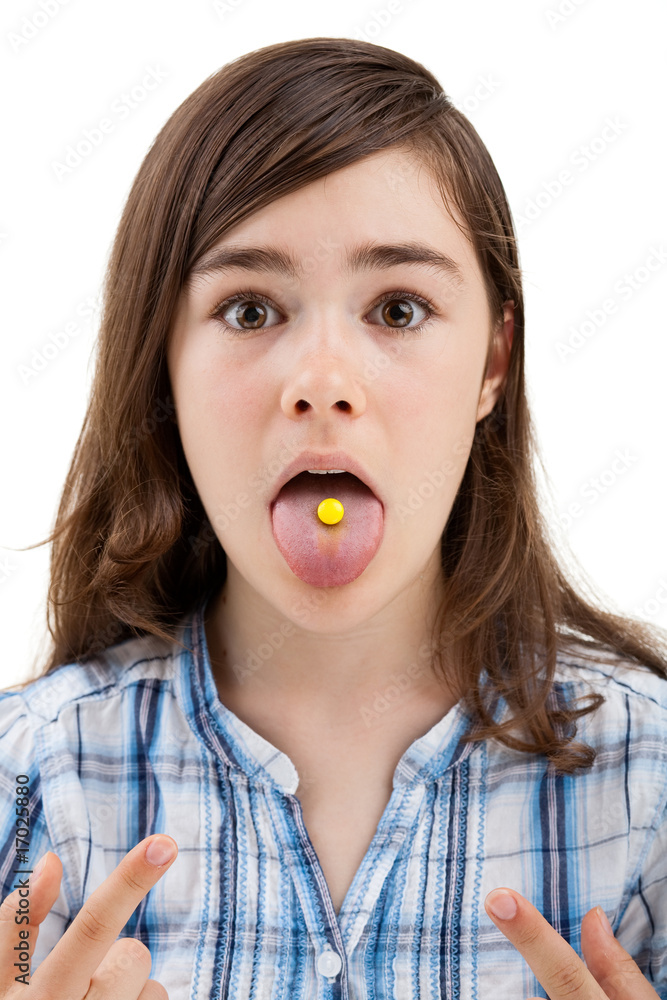 Girl taking pill isolated on white background Girl taking pill isolated on white background