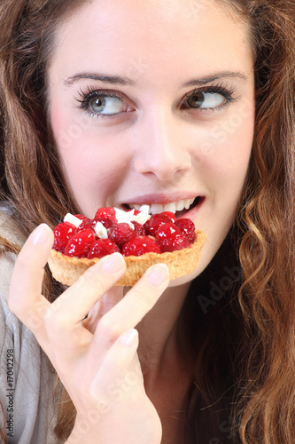 Quadro em tela jeune femme mange un gateau