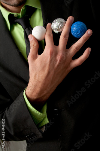 Mago haciendo un juego de manos con bolas photo