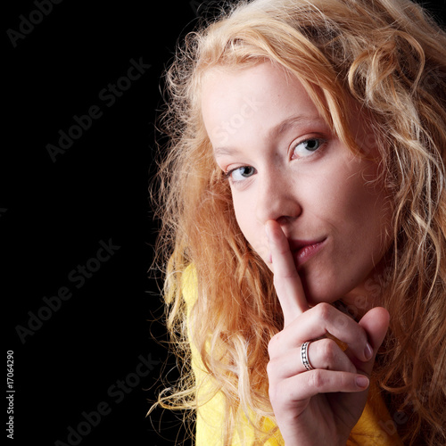 Teen girl with finger on her lips