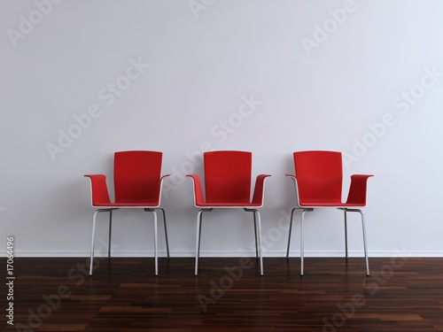 Three modern red Chais to face a blank white wall
