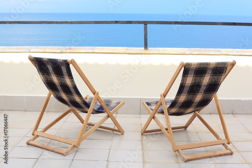 two longes on veranda on sea photo