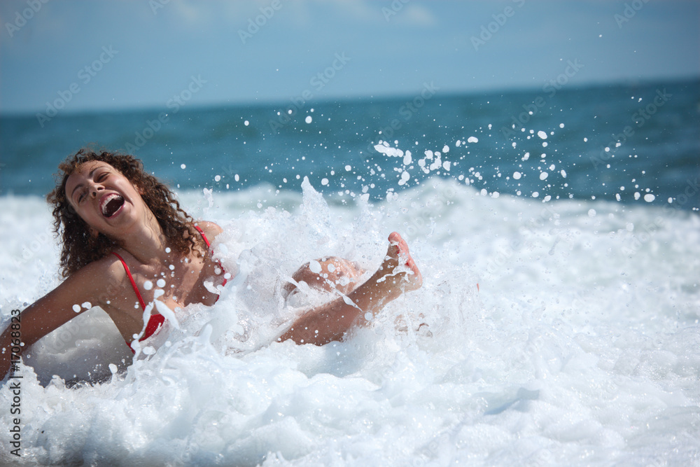 beauty girl sits in sea surf